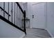 Inviting foyer with stylish staircase, sleek gray flooring, and a bright white front door for a modern entrance at 6722 S Winnipeg Cir # 102, Aurora, CO 80016