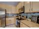 Stylish kitchen featuring modern appliances, updated cabinets, and designer backsplash at 6722 S Winnipeg Cir # 102, Aurora, CO 80016