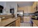 Well-appointed kitchen with stainless steel appliances, maple cabinets, and sleek countertops at 6722 S Winnipeg Cir # 102, Aurora, CO 80016