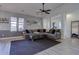 Comfortable living room with neutral tones, a ceiling fan and an oversized sectional at 6722 S Winnipeg Cir # 102, Aurora, CO 80016