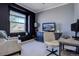 Cozy living room featuring a comfortable chair, a TV with a picturesque view, and ample natural light from the window at 6722 S Winnipeg Cir # 102, Aurora, CO 80016