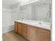 Bathroom featuring a double sink vanity with great lighting and a shower/tub at 7440 S Blackhawk St # 2-203, Englewood, CO 80112