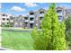 Exterior view of building with lush green lawn and manicured landscaping at 7440 S Blackhawk St # 2-203, Englewood, CO 80112