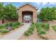 Community clubhouse entrance featuring stone facade and landscaped walkway at 7440 S Blackhawk St # 2-203, Englewood, CO 80112