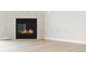 Close up view of the fireplace with white tile surround and dark firebox at 7440 S Blackhawk St # 2-203, Englewood, CO 80112