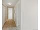 Hallway with carpeted floors, white walls, and multiple doorways at 7440 S Blackhawk St # 2-203, Englewood, CO 80112