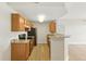 Bright kitchen features granite countertops, wood cabinets, and modern appliances with light colored flooring at 7440 S Blackhawk St # 2-203, Englewood, CO 80112