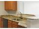 Kitchen boasts granite counters, stainless dishwasher, and wooden cabinets at 7440 S Blackhawk St # 2-203, Englewood, CO 80112