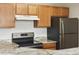 This kitchen features stainless appliances, granite counters, and wood cabinets at 7440 S Blackhawk St # 2-203, Englewood, CO 80112