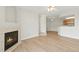 Open concept living room with laminate floors, neutral paint, and a cozy fireplace at 7440 S Blackhawk St # 2-203, Englewood, CO 80112