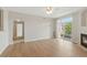 Bright, open living area with laminated floors, fireplace, and sliding glass door to the outside at 7440 S Blackhawk St # 2-203, Englewood, CO 80112