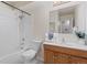 Bright bathroom features a tiled shower/tub, modern sink, oak vanity, and neutral walls at 12053 E Harvard Ave # 107, Aurora, CO 80014
