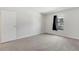 A carpeted bedroom featuring a window and closet door is freshly painted and ready to be customized at 12053 E Harvard Ave # 107, Aurora, CO 80014
