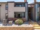 Attractive condo exterior featuring stone landscaping, private patios, and convenient stairway access at 12053 E Harvard Ave # 107, Aurora, CO 80014