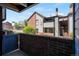 Cozy patio area view of the building, and a brick wall feature adding privacy at 12053 E Harvard Ave # 107, Aurora, CO 80014