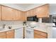 Modern kitchen with updated appliances, sleek countertops and ample natural light at 12053 E Harvard Ave # 107, Aurora, CO 80014