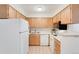 Functional kitchen with ample counter space, wooden cabinetry, and modern appliances at 12053 E Harvard Ave # 107, Aurora, CO 80014