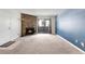 Inviting living room features neutral carpet, a stone fireplace, and sliding glass doors at 12053 E Harvard Ave # 107, Aurora, CO 80014