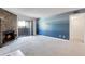 Bright living room featuring neutral carpet, a stone fireplace, and sliding glass doors at 12053 E Harvard Ave # 107, Aurora, CO 80014