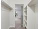 Spacious walk-in closet featuring shelving and hanging space with a view into the bedroom at 12053 E Harvard Ave # 107, Aurora, CO 80014