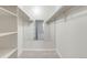 Bright, well-organized walk-in closet featuring multiple levels of shelving with mirror at rear at 12053 E Harvard Ave # 107, Aurora, CO 80014