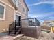 Backyard view of the elevated deck with stairs and stone paver patio at 12627 Fisher Dr, Englewood, CO 80112