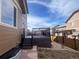 View of the backyard with a deck, gravel landscaping, and privacy fence at 12627 Fisher Dr, Englewood, CO 80112