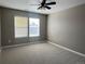 This bedroom features neutral paint, natural light, and an overhead ceiling fan at 12627 Fisher Dr, Englewood, CO 80112