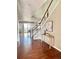 Hallway features hardwood floors, stairs with white railings, and plenty of natural light at 12627 Fisher Dr, Englewood, CO 80112