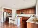 Modern kitchen with stainless steel appliances, a large island, and hardwood floors at 12627 Fisher Dr, Englewood, CO 80112