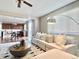 Well-lit living room adjacent to kitchen featuring stylish furniture and decor at 12627 Fisher Dr, Englewood, CO 80112