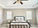 Comfortable bedroom featuring neutral colors, a ceiling fan, and natural light from the windows at 12627 Fisher Dr, Englewood, CO 80112