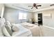 Bright primary bedroom with a soft color scheme, plush bedding, and ensuite bathroom at 12627 Fisher Dr, Englewood, CO 80112