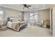 Cozy primary bedroom with tray ceiling and plush carpet, complemented by natural light at 12627 Fisher Dr, Englewood, CO 80112