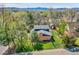 Aerial shot of the house, showcasing its backyard, mature trees, and neighborhood setting at 12821 W 60Th Ave, Arvada, CO 80004