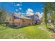 Expansive backyard with a well-maintained lawn, brick accents, and secure fencing for privacy at 12821 W 60Th Ave, Arvada, CO 80004