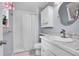 Bright bathroom features tiled countertop and backsplash, framed mirror, and a tiled shower with curtain at 12821 W 60Th Ave, Arvada, CO 80004