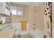 Updated bathroom features tile floor, tub/shower, and built-in shelving at 12821 W 60Th Ave, Arvada, CO 80004
