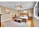 Bedroom showcasing a natural wood bed frame, hardwood floors, closet with mirror, and modern ceiling fan at 12821 W 60Th Ave, Arvada, CO 80004