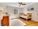 Cozy bedroom with hardwood floors, two windows, and wood furnishings at 12821 W 60Th Ave, Arvada, CO 80004