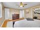 Bedroom showcasing a natural wood bed frame, hardwood floors, and view of the ensuite bathroom at 12821 W 60Th Ave, Arvada, CO 80004