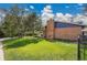 Charming brick home with a lush green yard, blue siding, mature trees, and an inviting covered porch at 12821 W 60Th Ave, Arvada, CO 80004