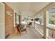 Exterior view of a cozy front porch with ample seating and brick exterior detailing at 12821 W 60Th Ave, Arvada, CO 80004