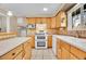 Galley kitchen with white appliances, tile backsplash, and bright natural light at 12821 W 60Th Ave, Arvada, CO 80004