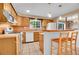 Traditional kitchen with tile floors, oak cabinets and breakfast bar seating at 12821 W 60Th Ave, Arvada, CO 80004