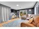 Living room featuring a large sofa, wood floors, bright windows, and TV with a work-from-home setup at 12821 W 60Th Ave, Arvada, CO 80004