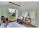 Inviting shed interior with a comfortable chair and view of the backyard through an open door at 12821 W 60Th Ave, Arvada, CO 80004