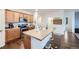 Kitchen island with a tan countertop and a built-in sink at 830 Draw St, Brighton, CO 80603