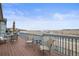 Outdoor back deck features seating, overlooking a serene view of a lake and open landscape at 26741 E Peakview Pl, Aurora, CO 80016