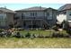 Two story home featuring well-manicured backyard with a deck, patio, and lush landscaping at 26741 E Peakview Pl, Aurora, CO 80016